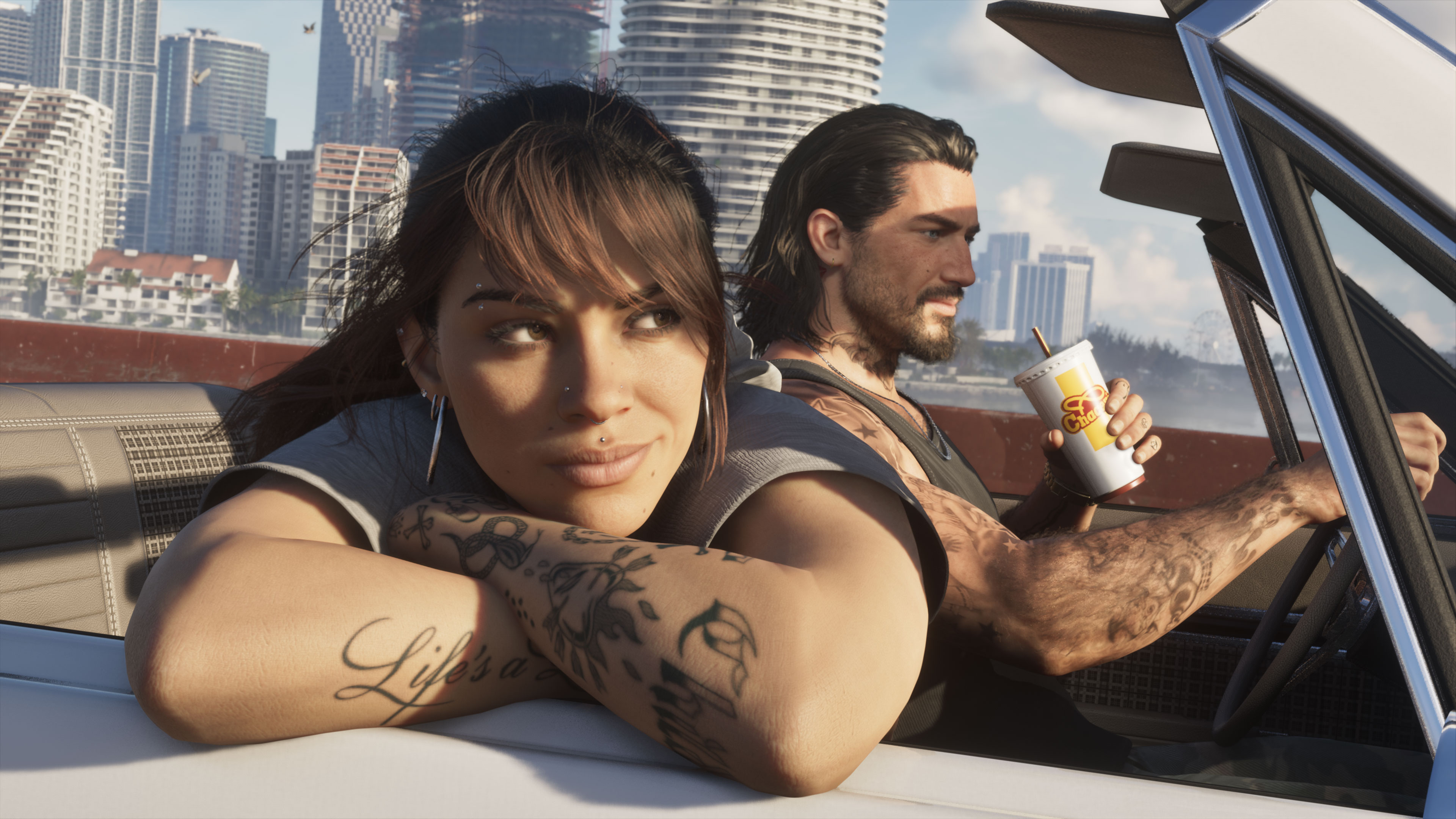 Lucia and Jason in a white convertible with a Cluckin' Bell cup, Vice City behind them
